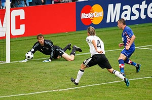 Germany's goalkeeper Jens Lehmann (L) and team mate Clemens Fritz (C) react as the ball bounces back off the post in the direction of Croatia's Ivica Olic for him to score his team's second goal 